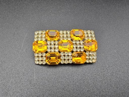 Orange and white rhinestone brooch